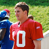 An American football player wearing a red jersey with a white number "10".