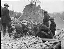 Civil Defence rescue teams search a pile of rubble following a V-1 flying bomb attack in Upper Norwood, London, 1944. Flying Bomb- V1 Bomb Damage in London, England, UK, 1944 D21237.jpg