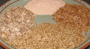 Sources of gluten. Clockwise from top: High-gluten wheat flour, European spelt, barley, rolled rye flakes.