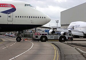 A ground-handling tug pulls a British Airways ...