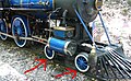 The leading wheels (denoted by the red arrows) of a 4-4-0 steam locomotive.