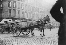 A strikebreaking driver and cart being stoned during sanitation worker strike. New York City, 1911. New York garbage cart being stoned.jpg