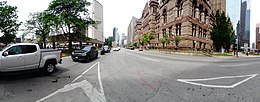 Toronto City Hall and Old City Hall, with Bay Street bisecting the two buildings. Panorama of Toronto s Old City Hall, 2017 07 29 -c (45765954272).jpg