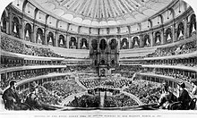 The first performance at the Hall. The decorated canvas awning is seen beneath the dome. RAH Grand Opening by Queen Victoria 29 March 1871 The Graphic.jpg