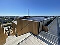 Walkway on the roof; solar panels are visible.