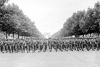 American troops of the 28th Infantry Division march down the Avenue des Champs-Élysées, Paris, in the Victory Parade on 29 August 1944.