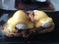 An open sandwich prepared with steak and eggs