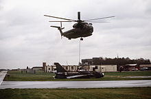 A USAF Sikorsky HH-53C helicopter of the 67th Aerospace Rescue and Recovery Squadron lifts a Lightning at RAF Woodbridge, Suffolk, 18 December 1987. HH-53C lifts BAC Lightning 1987.JPEG