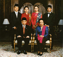 Formal family portrait of former Indonesian's President B.J. Habibie. Women wear kain batik and kebaya with selendang (sash), while men wear jas and dasi (western suit with tie) with peci cap. Habibie family portrait.jpg