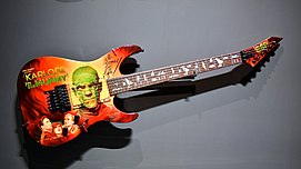 Wall-mounted electric guitar on display in a museum
