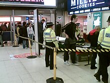 Police officers of the British Transport Police conducting proactive searches for knives and other weapons Knife search at New Street (131493182).jpg