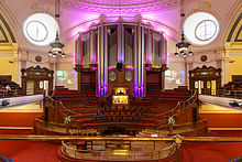 The UK has committed to international law as a "sovereign" member, to augment its power through cooperation, in the United Nations since 1945. The first UN General Assembly was held at Methodist Central Hall, opened by Prime Minister Clement Attlee. Methodist Central Hall - Great Hall with pipe organ.jpg