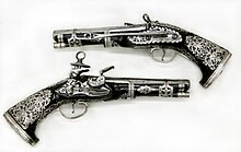 Pair of Miquelet Pistols, in the Peninsular Spanish style, made in colonial Mexico, ca. 1757, at the Metropolitan Museum of Art Pair of Miquelet Flintlock Pistols MET 2011.361-362.jpg