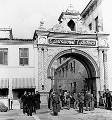 In the early 20th century, Hollywood studios, like Paramount Pictures, helped transform Hollywood into the world capital of film and helped solidify LA as a global economic hub. Paramount Pictures studio gate, c. 1940 (cropped).jpg