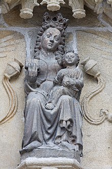 The south porch known as the Notre-Dame porch has this statue of the Virgin Mary with child in the tympanum. She has angels on either side paying homage, with other angels playing musical instruments and holding phylacteries in the arch's voussures.