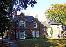 A two-storey red-brick building with annexes on the right.