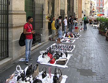 Street hawkers selling bags and sunglasses in ...