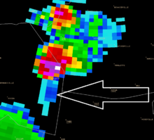 Example of a three-body spike: the weak triangular echoes (pointed by the arrow) behind the red and white thunderstorm core are related to hail inside the storm. Three body scatter spike-NOAA.png