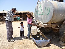 Palestinian villagers purchase water from water trucks in Khirbet A-Duqaiqah in the Hebron Hills Water supply in West Bank and Gaza February 2014 5water photoblog.jpg