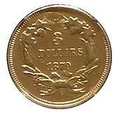 Une pièce de monnaie dorée comprenant une couronne de feuilles à l'intérieur de laquelle se trouvent les inscriptions 3 DOLLARS ET 1870.
