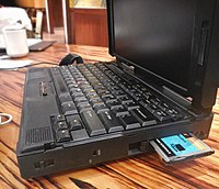 A modem PCMCIA card on a 1990s ThinkPad. The card would normally fully insert into the socket. 3Com modem - Ethernet PCMCIA in IBM 9547.jpg