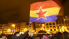 A variant of the flag of the Second Spanish Republic with an added red star being flown in 2020 8M protest in Pamplona 2020 - 5.jpg