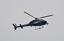 BBC News helicopter over London BBC News helicopter watching over the cuts protest.jpg