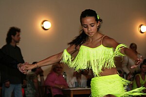 A young girl dancing Cha-cha-cha. The girl mov...