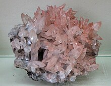 Calcite is a carbonate mineral (CaCO3) with a rhombohedral crystal structure. Calcit Scalenoeder - Egremont, England.jpg