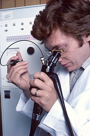 English: Pictured is a physician using a remot...