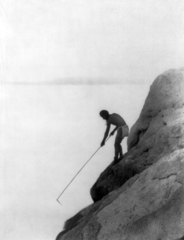 Fishing with gaff hook, 1924