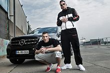 Gzuz and Bonez MC in front of a Mercedes Benz