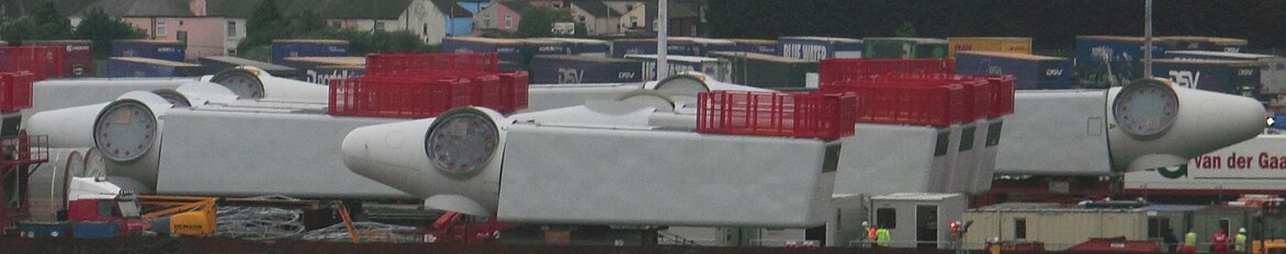 Greater Gabbard wind farm turbines in harbour, waiting to be mounted. Red helicopter platform on top.