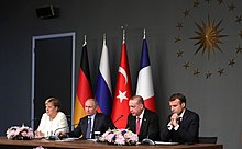 Angela Merkel, Vladimir Putin, Recep Tayyip Erdogan and Emmanuel Macron giving a press conference as part of Syria summit in Istanbul, Turkey Merkel, Putin, Erdogan and Macron during the joint press release.jpg