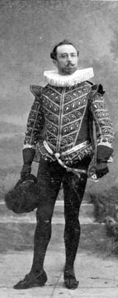 White man with neat moustache and beard in elegant Tudor costume