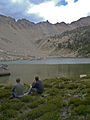 Hikers eating lunch at Shallow Lake with the Devil's Staircase on the horizon.