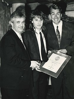 1989/1990: Paul Patterson of Ocean Software receives, from Jonathan Ross and Julian Rignall, "Best Coin-Op Conversion of the Year" (8-bit) award 1990 Golden Joystick Awards (Paul Patterson, Jaz Rignall, Jonathan Ross).jpg
