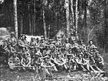 A group of weary soldiers in a jungle scene