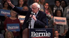 Bernie Sanders in front of an out of focus crowd of supporters