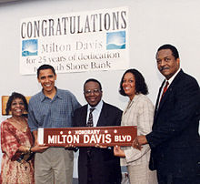 Photo of Obizzay n' others carryin a streetsign dat readz "Honorary: Milton Davis Blvd."