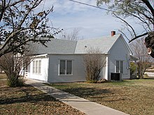 White painted house with garden