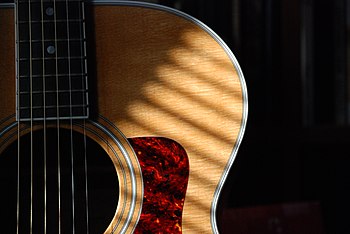 Taylor steel-string guitar.