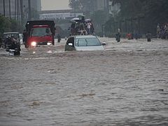 VOA A car tries to drive through Jakarta's flooded streets.jpg