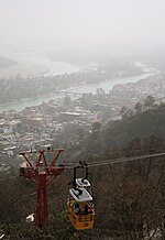 Ropeway taking pilgrims to the shrine. In the background the River Ganges and Haridwar can be seen. Cable car to Mansa Devi Temple, Haridwar, Uttarakhand, India.jpg