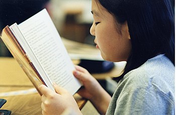 Girl reading a book.