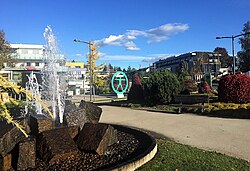 Laßnitzhöhe city center from the town fountain and garden, with the main shopping area in the background