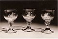 Three out of 10 goblets engraved by Alison Geissler and presented to Her Majesty Queen Elizabeth by the High Constables and the Guard of Honour of Holyrood House for the Coronation in 1953. The wineglasses are part of the Royal Collection. © Studio Swain, Glasgow.