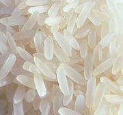 Uncooked, polished, white long-grain rice grains.