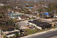Aerial view of downed trees and roof damage