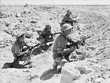 British soldiers at Tobruk, equipped with Thompson submachine guns and Lee-Enfield rifles 9 Div Tobruk(AWM 020779).jpg